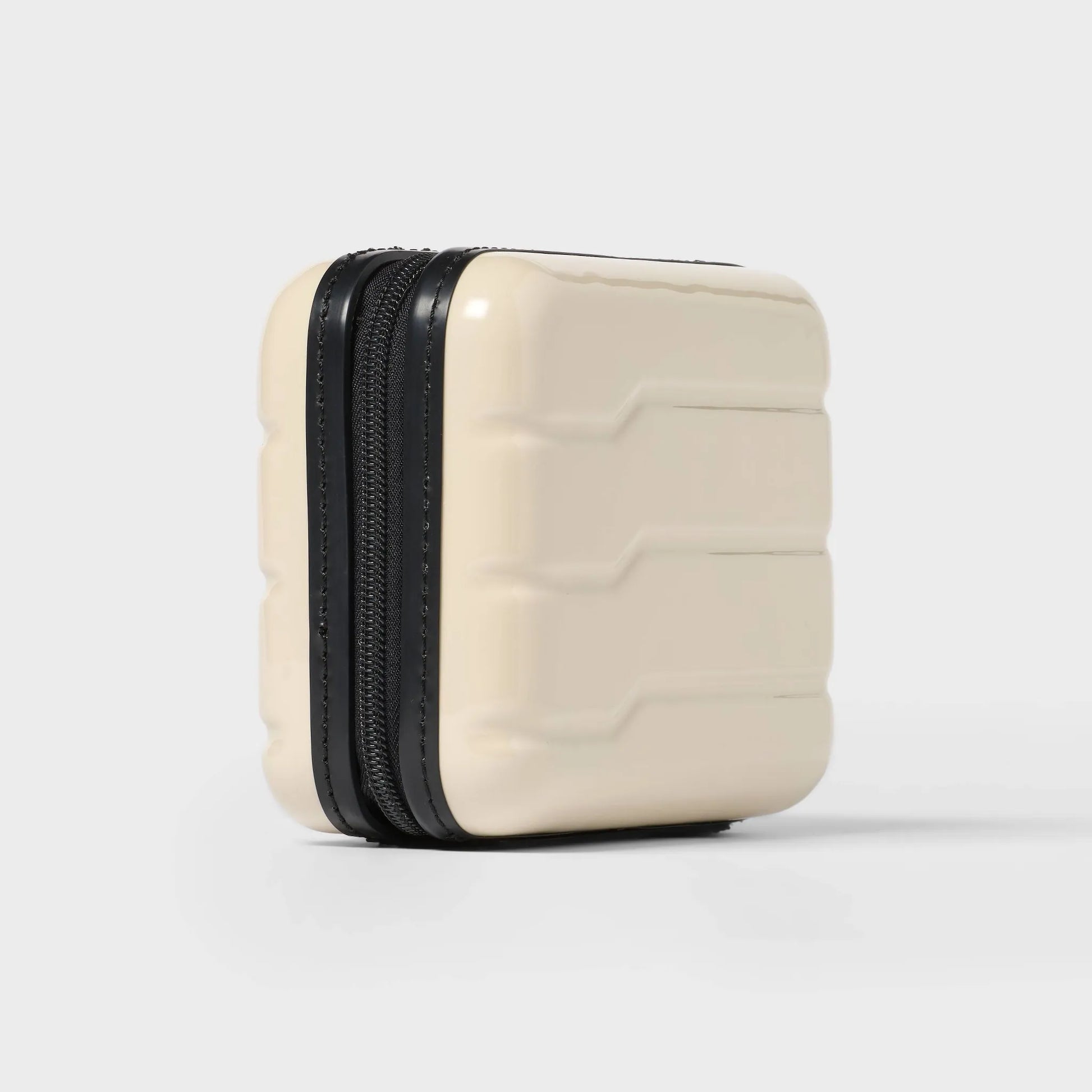 Off-white hardside Dopp Kit Case with a spacious main compartment and secure zipper closure