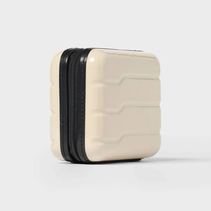 Off-white hardside Dopp Kit Case with a spacious main compartment and secure zipper closure
