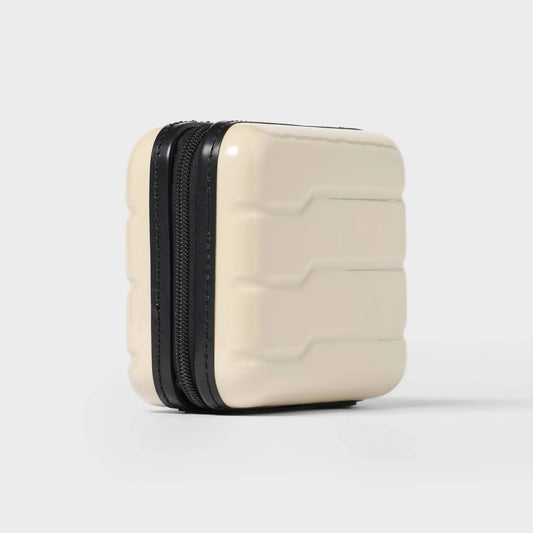Off-white hardside Dopp Kit Case with a spacious main compartment and secure zipper closure
