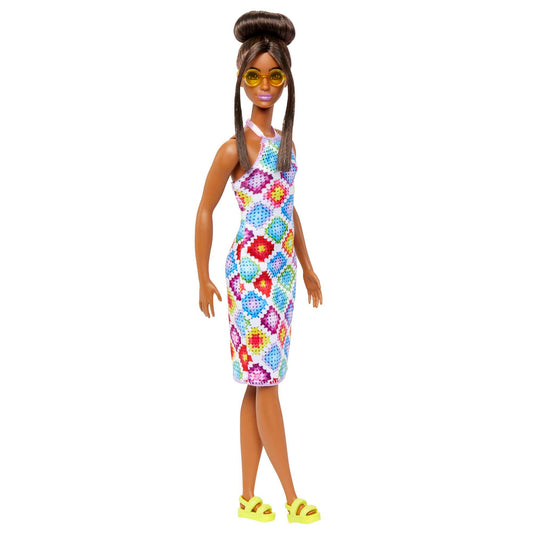 Barbie Fashionistas doll with brown hair in bun, wearing colorful crochet halter dress, sunglasses, and sandals