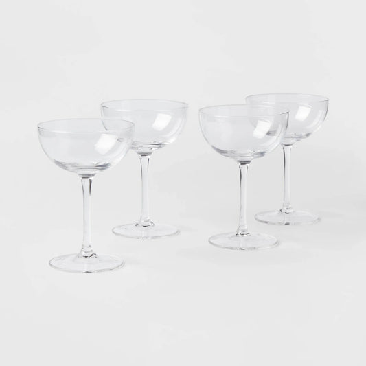 Elegant 4-pack of Threshold glass cocktail coupe glasses, perfect for serving champagne or cocktails.