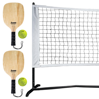 Franklin Sports Pickleball Net Set with two wooden paddles and two pickleballs on a portable outdoor net